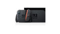 Nintendo Switch 2 with Joy-Con 2 in the grip, next to the dock, front view